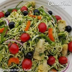 a white plate topped with pasta and veggies