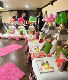 a living room filled with lots of furniture and balloons