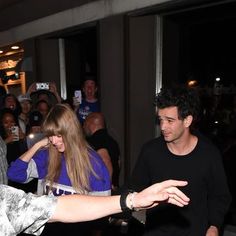 a man and woman dancing in front of a crowd