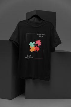 Unleash your inner gamer with our Retro Puzzle Piece T-Shirt, featuring a unique and eye-catching design that seamlessly blends vintage gaming elements with a classic puzzle motif. This unisex casual tee is perfect for gaming enthusiasts and puzzle lovers alike, offering a comfortable and stylish addition to your wardrobe. Made from high-quality, soft fabric, this t-shirt is designed to keep you comfortable whether you're gaming, hanging out with friends, or simply enjoying a day out. Available Graphic Print Crew Neck T-shirt For Gaming Events, Gaming Event Crew Neck T-shirt With Letter Print, Black Graphic Print Tops For Gaming Events, Black Gamer T-shirt With Letter Print, Black Gamer T-shirt With Graphic Print, Black Gamer T-shirt With Screen Print, Black Gaming Tops With Graphic Design, Black Short Sleeve Gamer T-shirt, Graphic Tee T-shirt For Gaming Events