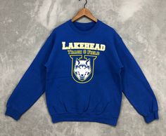 Vintage Lakehead University Sweatshirt Lakehead Track & Field Crewneck Blue University College Sweater Sports Unisex Size S  REF : NS1429 -THIS IS USED VINTAGE ITEM, PLEASE DONT EXPECT CONDITION WILL BE LIKE NEW. -ANY DEFECT ON ITEM WILL BE PROVIDE ON PHOTO. -PLEASE ASK ME IF HAVE ANY DOUBTS ABOUT THIS ITEM EXPECIALLY SIZE MEASUREMENT SIZE  : S CONDITION : GOOD CONDITION.PLEASE REFER PHOTO PHOTO FOR MORE DETAILS. PIT (ARMPIT TO ARMPIT): 21.5 INCH LENGTH ( TOP TO BOTTOM) : 26.5  INCH  SLEEVE : 23 INCH MATERIAL: COTTON AND POLYESTER  SHIPPING : IM USING DHL EXPRESS FOR SHIPMENT.TRACKING NUMBER WILL BE PROVIDE AFTER ITEM PICK UP BY COURIER. PROCESSING TIME : 1-3 BUSINESS DAYS Blue T-shirt For Winter Sports, Blue Streetwear Sweatshirt With Team Name, Blue Sweatshirt With Team Name For Streetwear, Blue Sweatshirt With Team Name For Sports Season, Blue Team Name Sweatshirt For Sports Season, Blue Crew Neck Sweatshirt For Sports Events, Blue Crew Sweatshirt For Sports Events, Blue Team Spirit Sweatshirt For Sports Season, Collegiate Blue Sweatshirt For Sports