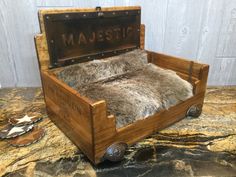 an old fashioned wooden box with fur on the inside and metal lettering that reads maustop