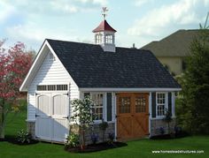 a small white shed with a steeple on top