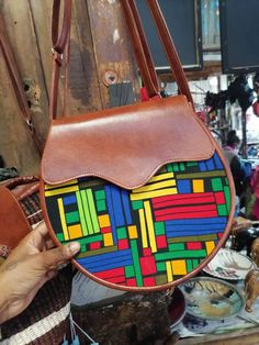 Our beautiful handwoven bag is  designed in a unique way and can be customized to our clients own liking,suitable for any occasion, made of kitenge fabric and leather on the side. Multicolor Handheld Leather Shoulder Bag, Leather Bags With Adjustable Strap, Trendy Leather Tote Flap Bag, Leather Rectangular Flap Bag, Rectangular Leather Flap Bag Fashion Accessory, Leather Satchel Fashion Accessory Bag, Leather Crossbody Bags As Fashion Accessory, Traditional Leather Crossbody Satchel, Multicolor Leather Shoulder Satchel