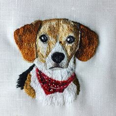 a dog with a red bandana on it's collar is embroidered onto a white shirt