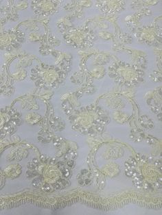 an image of a white lace with gold flowers on it's edge and sequins in the middle