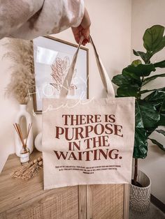 "There is Purpose in the Waiting Tote Bag (THIS ITEM IS FINAL SALE; NO RETURNS OR EXCHANGES) BAG COLOR: Natural Screen print Transfer MEASUREMENTS-- Flat: 14 3/4\"W x 14 3/4\"H x 5\"D Expanded: 19 1/2\"W x 14 3/4\"H x 5\"D -26\" webbed handles MATERIAL-- -100% Cotton Canvas MORE TOTE DETAILS: *No top closure *CANNOT be customized *Spot clean" Inspirational Tote Bags For Everyday Use, Bible Tote Bag, Tote Bag Christian, Christian Tote Bags, Screen Print Transfer, Print Transfer, Trendy Tote, Cotton Tote Bag, Planning Ahead