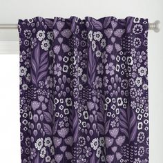 a purple curtain with white flowers and leaves on it