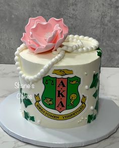 a decorated cake with a pink rose on top