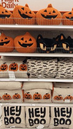 pumpkins and pillows are on display in a store