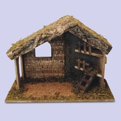 a small house made out of bricks and wood with a thatched roof on top