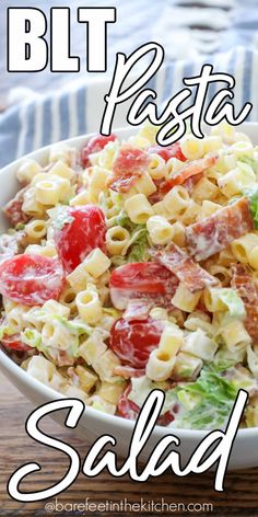 a bowl filled with pasta salad on top of a wooden table