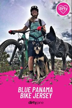 a woman on a bike with two dogs