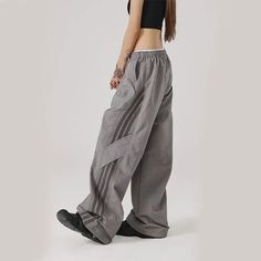 SPECIFICATIONSBrand Name: GIDYQStyle: High StreetAge: JUNIOROrigin: Mainland ChinaCN: GuangdongSeason: SummerWaist Type: highDecoration: STRAPElasticity: Slight StrechFabric Type: FlannelPattern Type: StripedPant Style: Cargo PantsMaterial: POLYESTERFit Type: LOOSELength: full lengthRelease Date: Spring 2024Place Of Origin: China (mainland)Closure Type: Elastic WaistGender: WOMENModel Number: MD04081Front Style: FlatChoice: yes Trendy Baggy Pants For Sports, Gray Baggy Parachute Pants For Streetwear, Gray Streetwear Pants, Parachute Sweatpants, Streetwear Cargo Pants, Junior Pants, Baggy Streetwear, Black Wide Leg Trousers, Y2k Baggy