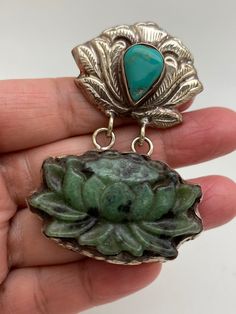 This beautiful pendant Lotus flower carved on ruby zoisite stone is set with turquoise This beautiful pendant was handcrafted in Nepal in Tibetan silver. The measurement of pendant is approximately 70mmX43mm It weighs about 35gm Artisan Jade Pendant Jewelry, Bohemian Carved Sterling Silver Jewelry, Bohemian Jade Pendant Jewelry, Green Turquoise Pendant Necklace Spiritual Style, Green Turquoise Pendant Necklace With Spiritual Style, Green Turquoise Spiritual Pendant Necklace, Spiritual Green Turquoise Pendant Necklace, Artisan Carved Jade Jewelry, Bohemian Carved Jewelry For Healing