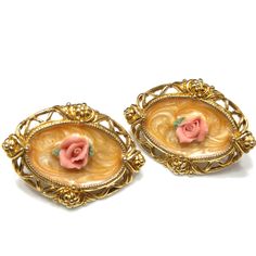 *Description: This is a beautiful set of 1928 style jewelry with a brooch and matching earrings that each has the porcelain rose in pink in the center with tiny green porcelain petals from the 1980s. Each piece has the rose sitting on a peach tone creamy enamel. I tested the gold surface metal on each piece and they tested as 18K gold plate. The earrings have posts and are pierced and the brooch has a rolling c clasp. 1928 is not signed but this set does not have a large swirling pattern as most Vintage Rose Brooch Jewelry, Vintage Rose Jewelry With Brooch, Vintage Pink Clip-on Earrings For Formal Occasions, Vintage Peach Jewelry For Gifts, Vintage Rose Brooch, Vintage Rose Design Jewelry For Formal Occasions, Green Porcelain, Pink Porcelain, Formal Earrings