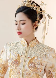 Color: gold Silhouette: A-line Length: long Neckline: mandarin collar Sleeves: three-quarter Fabric: satin Material: polyester Details: sequin embroidery, peacock embellishment A gold Chinese wedding dress for women Captivate everyone by your presence in a gold Chinese wedding dress at the ceremony. Exude elegance and style in this stunning bridal gown made in a luxurious golden shade and decorated with exquisite embroidery. Timeless and chic, this Chinese wedding dress has a charming style and Peacock Embellishment, Modern Qipao Wedding, Qipao Wedding Dress, Cheongsam Wedding Dress, Embroidery Peacock, Qun Kwa, Tailored Wedding Dress, Cheongsam Wedding, Wedding Dress For Women