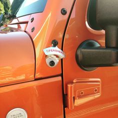 an orange truck with the door handle on it's side