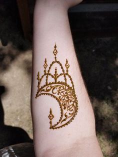 a person's arm with a henna tattoo on it