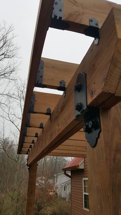 a wooden structure with metal brackets attached to it