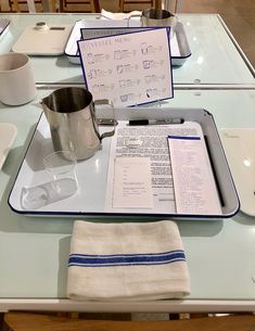 there is a menu on the table with cups and saucers