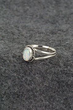 This opalite and sterling silver ring was made by Navajo silversmith Jan Mariano. The back is stamped sterling.Size: 8.5Length: 3/8"Width: 5/16"Free shipping on all orders! We ship with USPS and always include tracking. All orders ship within a day of payment.Returns are accepted up to 30 days after you receive your order. Just send us a message. Our shop offers cash back or store credit. The item must be returned in new condition. Bear Carving, White Buffalo, Pearl Chain, Native American Jewelry, Free Jewelry, Sterling Silver Ring, White Vintage, Silver Ring, Sterling Silver Rings