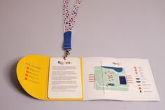 an open book with a lanyard attached to it's front cover and inside pages