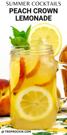 a mason jar filled with lemonade and sliced apples