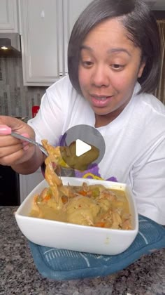 a woman is spooning food out of a bowl