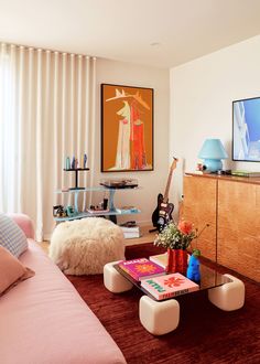 a living room filled with furniture and a painting on the wall