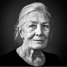 black and white photograph of an older woman with wrinkles on her face, looking at the camera