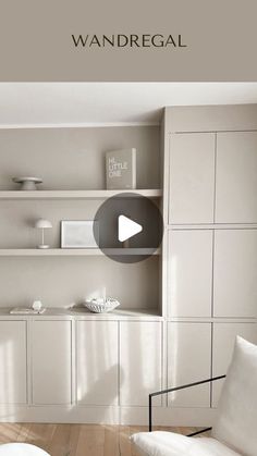 a living room filled with white furniture and lots of bookshelves on the wall