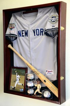 a baseball uniform and bat in a wooden case