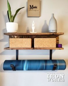 a shelf that has some items on it and is hanging from the wall next to a potted plant