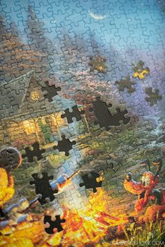 a jigsaw puzzle with an image of a house on fire in the background