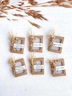 six small candles wrapped in brown paper and tied with twine