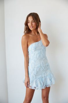 Hey babe, meet the baby blue dress of your dreams! The Livia One Shoulder Lace Ruffle Mini Dress is the perfect summer party dress. Featuring an asymmetrical neckline with an adjustable spaghetti strap, ruffle hem, and subtle white polka dots. Complete the fab look with the Ukari Clear Block Heel. Details 100% Polyester Fully lined Hidden back zip closure Material has minimal stretch Hand wash / Hang dry Sizing & Fit Fits true to size Model is 5'9 wearing a size small Model Measurements: Bust 34 Baby Blue Dress Short Formal, Sorority Formal Dresses Short, Hoco Dresses Ruffle, Blue Recruitment Dresses, Trendy Hoco Dresses 2024, Blue And White Mini Dress, Hoco Mini Dress, Homecoming Short Dresses, Sorority Recruitment Dresses