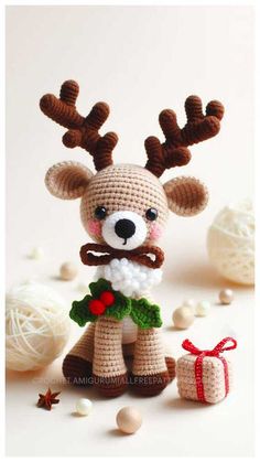 a crocheted reindeer is standing next to some balls