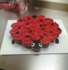 a cupcake shaped like a ladybug sitting on top of a table