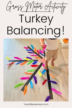 a toddler is playing with colorful feathers on the floor and text reads gross motor activity turkey balancing