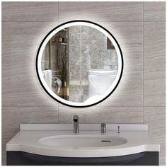 a bathroom sink with a round mirror above it