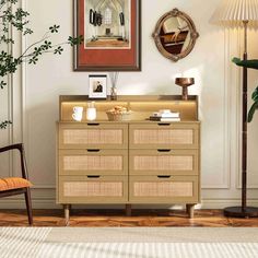 a living room scene with focus on the dresser and chair in the foreground as well as an art piece