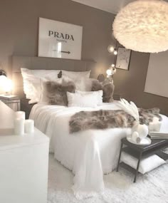 a bedroom with white bedding and fluffy fur on the comforter, pillows and lamps