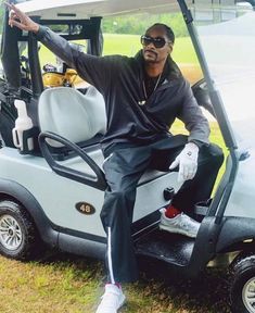 a man sitting on top of a golf cart