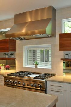 a stove top oven sitting inside of a kitchen