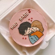 a pink cake decorated with an image of two people hugging and the words hbd babe on it