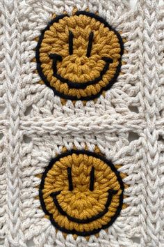 two crocheted smiley face patches on top of each other