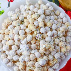 a white bowl filled with snowballs and sprinkles on top of a table