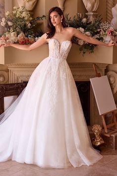 a woman in a white wedding dress posing for the camera with her arms spread out