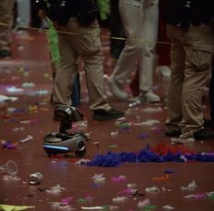 a group of people standing next to each other with confetti on the ground